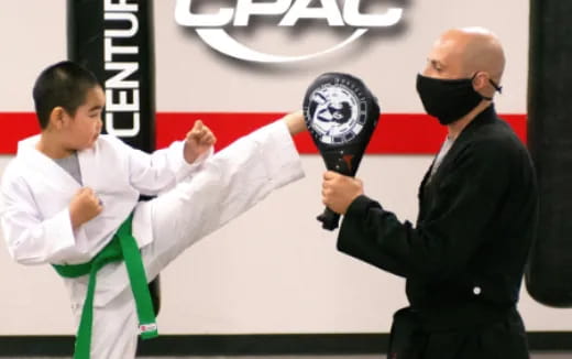 a man holding a microphone and a man holding a flag