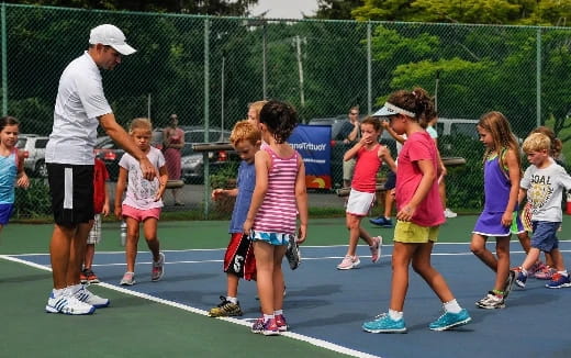 a group of kids running on a track