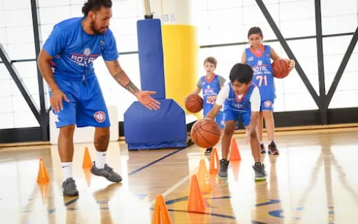 a group of kids playing basketball