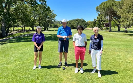 a group of people on a golf course