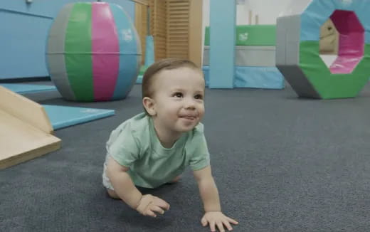 a baby lying on the floor