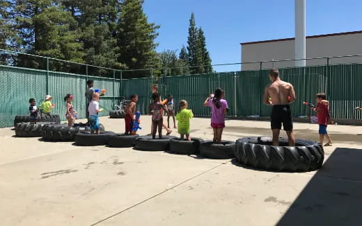 a group of people playing on a sand pit