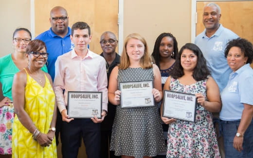 a group of people holding certificates