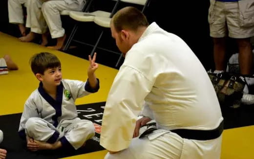 a person and a boy sitting on the floor