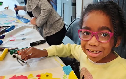 a girl with glasses smiling