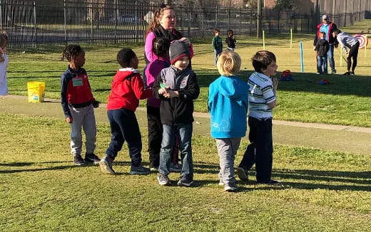 a group of children standing on a field