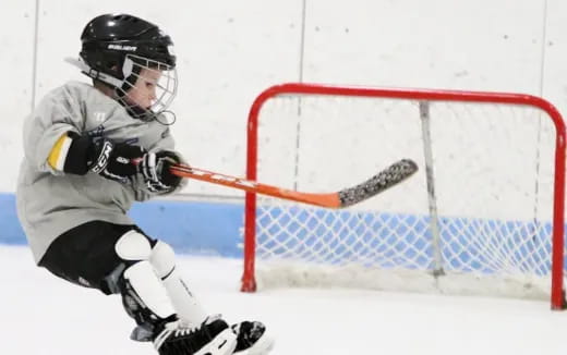 a hockey player in a white uniform