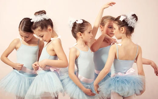 a group of girls in dresses