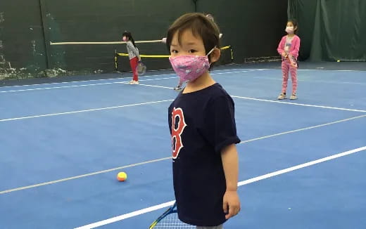a girl holding a tennis racket