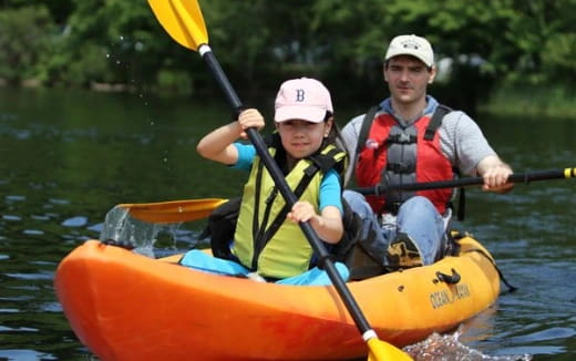a man and a boy in a canoe