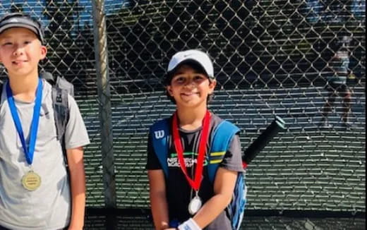 a couple of boys stand near each other