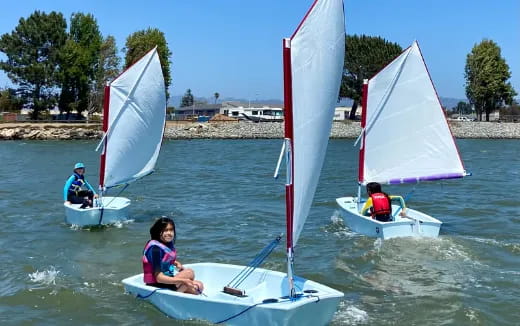 a group of people on small boats