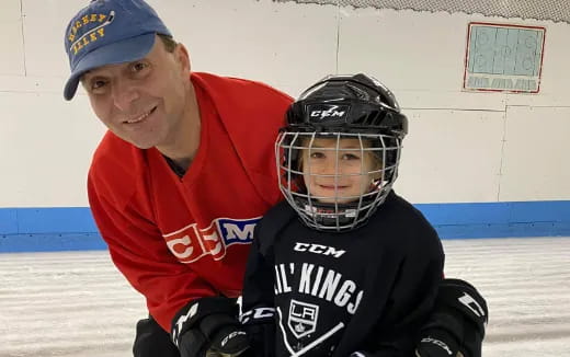 a man and a boy wearing hockey gear