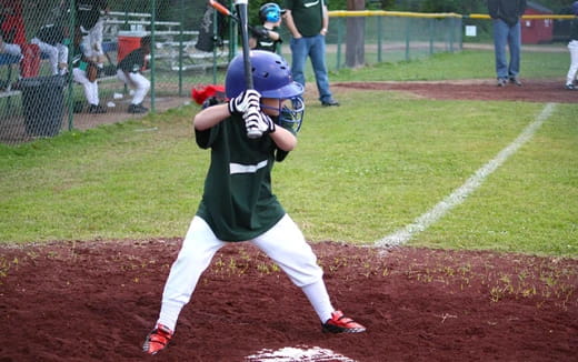 a kid holding a baseball bat