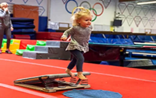 a girl jumping on a trampoline
