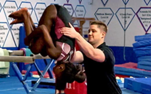 a man holding a woman in a gym