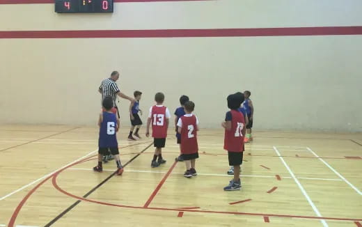a group of kids playing basketball