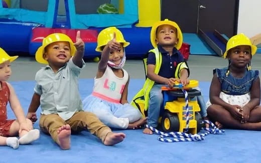 a group of children wearing yellow hats