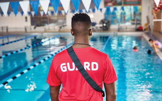 a man standing in front of a swimming pool