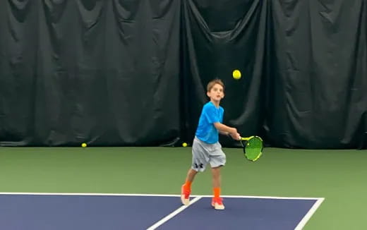 a boy playing tennis