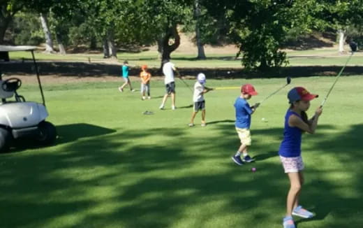 a group of people playing golf