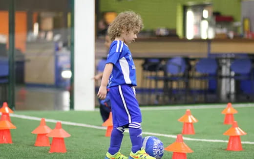 a young boy playing football