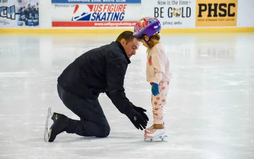 a man and a girl ice skating