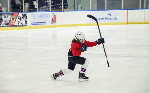 a young boy playing hockey