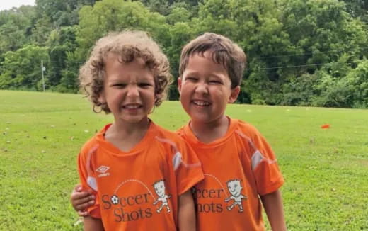 two boys in orange shirts