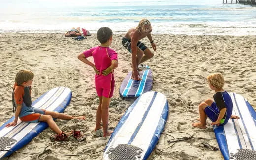 a group of kids playing on the beach