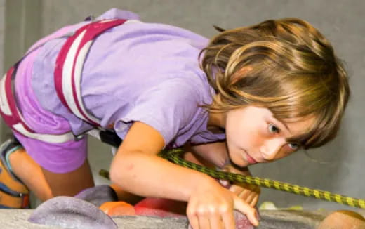 a young girl playing with a rope