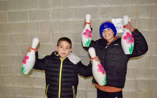 a couple of boys holding up ice cream cones