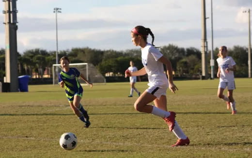 girls playing football on a field