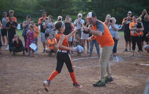 a group of people watching a person play a sport