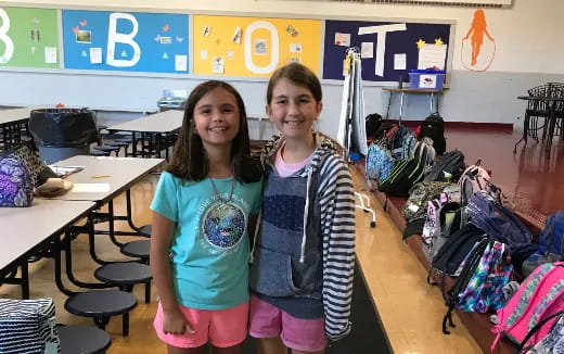 a couple of girls posing for the camera