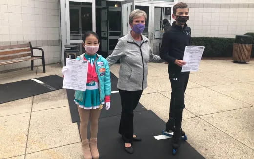 a group of people wearing masks and holding signs