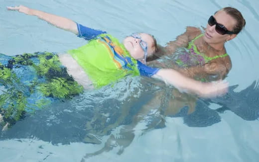 a person in a swimsuit floating in water