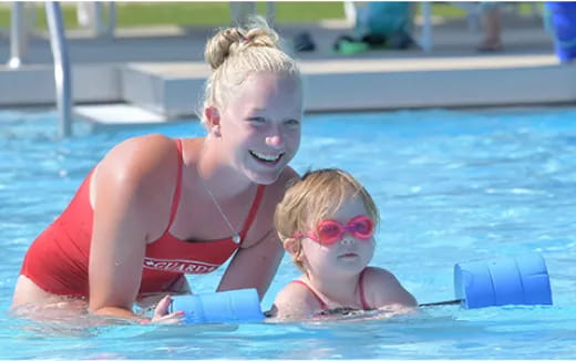 a person and a child in a pool