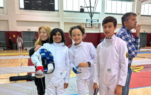 a group of people in white karate uniforms