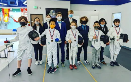 a group of people in white suits