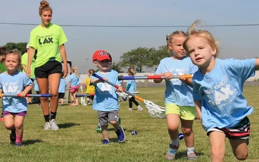 a group of kids playing with sticks