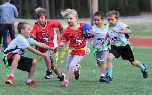a group of kids playing rugby