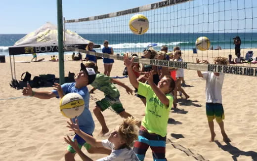 a group of people playing volleyball