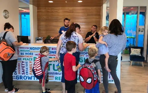 a group of people standing around a sign