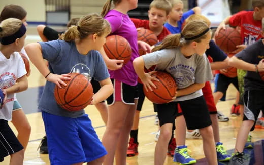 a group of girls playing basketball