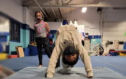 a person standing on a person's head