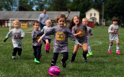 a group of kids playing football