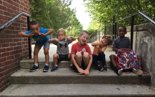 a group of kids sitting on steps