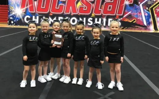 a group of girls in black uniforms