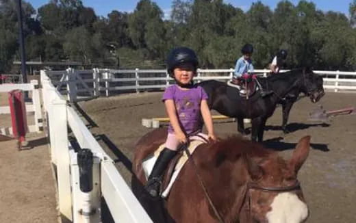 a girl riding a horse